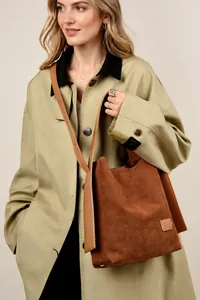Caramel suede bucket bag with wide shoulder strap shown with khaki trench coat