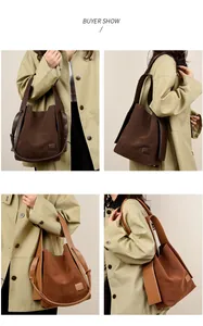 Detail showing the brown suede bucket bag with adjustable straps and branded patch