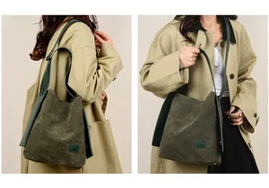 Close-up of retro dark green suede bucket bag with leather strap on a model