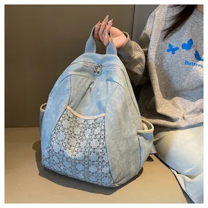 Detailed macro shot of blue denim backpack with rhinestone diamond lattice patterns