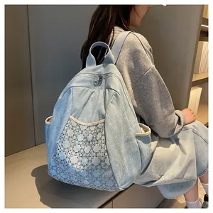 Light blue denim backpack featuring quilted diamond rhinestones on a back-worn model