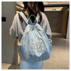 Detail shot of light blue denim backpack with rhinestone quilted pattern on a model's back