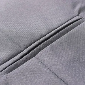 Detailed macro view of the grey woven fabric texture and neat stitching on casual suit jacket
