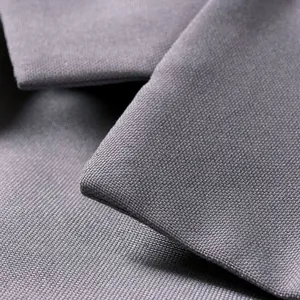 Macro detail of dark grey textured fabric with a fine cross-weave on this casual suit