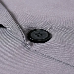 Macro view of gray twill suit fabric texture and durable four-hole black button detail