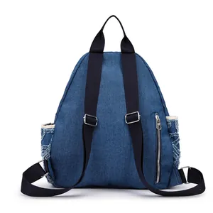 Back view of a blue denim backpack with rhinestone diamond quilting and black straps