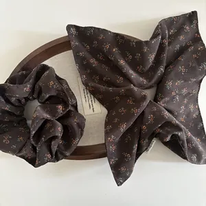 Detailed macro view of a brown floral scrunchie and matching handmade scarf set