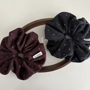 Retro polka dot fabric scrunchies in burgundy and charcoal grey with soft wool texture