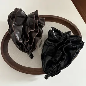 Elegant leather pleated banana hair clip in black and brown with glossy finish