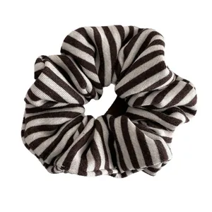 Minimalist brown and beige striped knit scrunchie with soft ribbed fabric texture