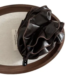 Dark brown leather pleated banana hair clip with elegant ruffled design for women