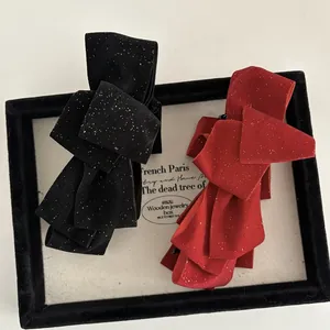Elegant velvet double-layered bow hair clips in red and black with gold glitter finish