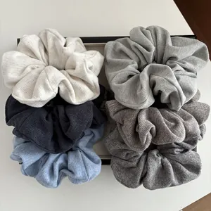 Set of five knitted oversized hair scrunchies in minimalist Morandi tones and ribbed texture