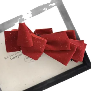 Sparkly red velvet double layer bow hair clip with gold glitter for festive hairstyles