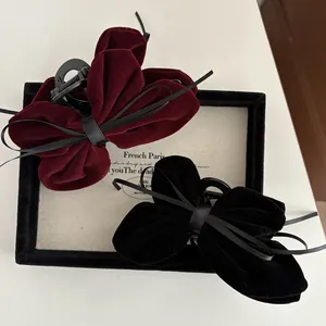 Elegant velvet bow hair claw clips in burgundy and black colors with ribbons