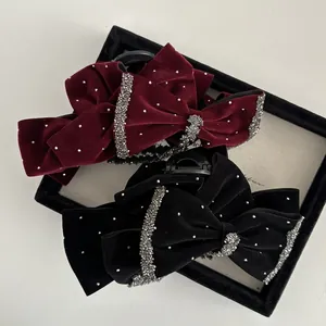 Elegant velvet hair claw clips with rhinestones and bow design in black and burgundy