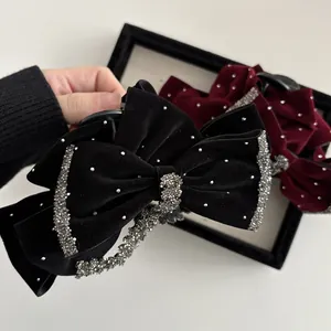 Elegant velvet bow hair claw clip with sparkling rhinestones in black and red
