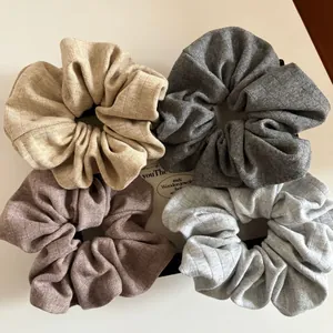 Set of four ribbed knit scrunchies in Morandi colors including beige, grey, and coffee