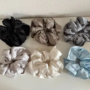 Set of 6 premium satin scrunchies in cream and dark tones for elegant hair styling