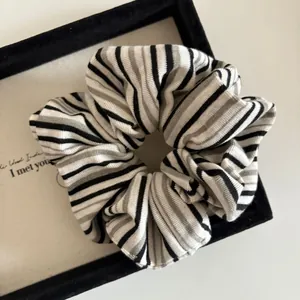 Macro shot of striped knit scrunchie with detailed texture and elastic band