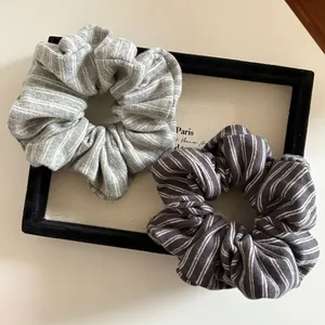 Two-pack of gray striped knit scrunchies in minimalist light and dark gray colors