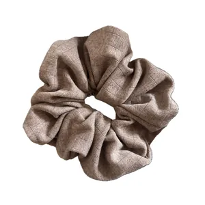 Taupe oversized ribbed knit scrunchie with high elasticity for elegant hair styling