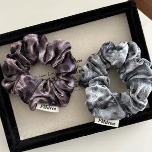 Retro velvet leopard print scrunchies in purple and blue with metallic luster finish