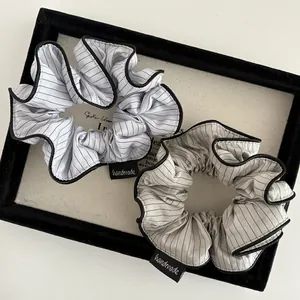 Striped scrunchies set with pleated texture and handmade label for elegant ponytails
