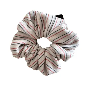 Striped knit scrunchie with red and black lines on soft white fabric for high ponytails