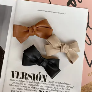 Three-piece set of textured PU leather bow hair clips in brown, beige, and black colors