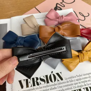 Elegant PU leather bow hair clips in various colors for women on fashion magazines