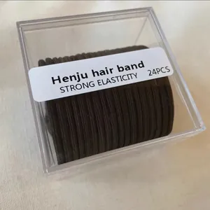 Macro view of 24 black high-elastic hair bands organized in a clear plastic storage box