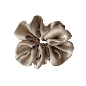 Elegant champagne satin scrunchie with a soft silk texture for hair accessories