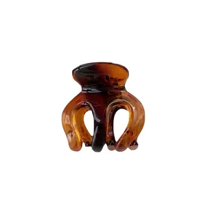 Minimalist amber tortoise shell hair claw clip with transparent glossy resin finish