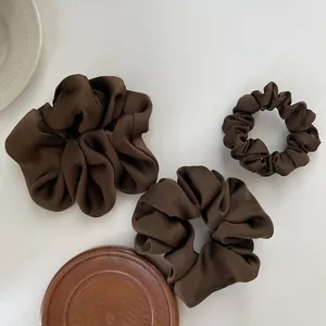 3-piece set of dark brown satin scrunchies in varied sizes on a clean white background
