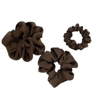 Three deep coffee satin silk scrunchies in various sizes on white background