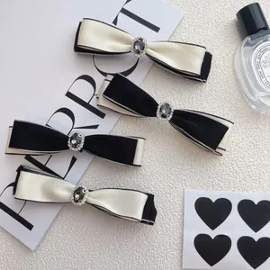 Vintage bow hair clips set with rhinestones and elegant black and white silk ribbon