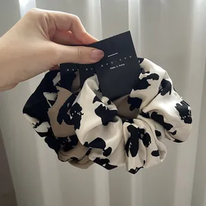 Three-piece satin scrunchie set in cream, khaki leopard print and solid black
