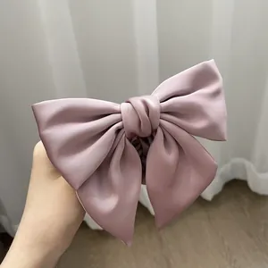 Elegant mauve satin bow hair scrunchie with a silky finish and voluminous design