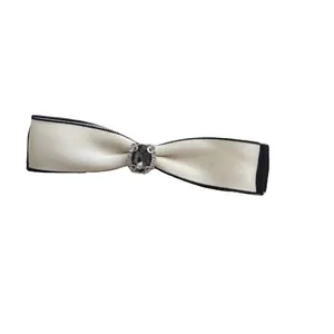 Elegant vintage bow hair clip with rhinestones and contrast edging on a white background