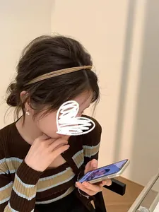 Elegant thin brown knotted headband shown on a model in a minimalist Korean style