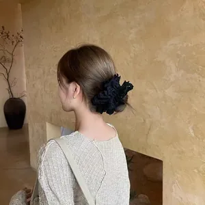 Elegant black lace hair scrunchie with layered ruffles and hollow embroidery on hair