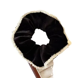 French style black velvet scrunchie with pearl trim and gold metal logo tag detail
