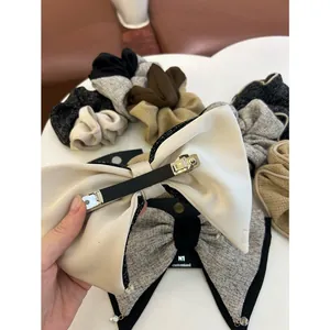 Détail d'un lot de chouchous en tweed et satin avec pince à nœud et perles fines
