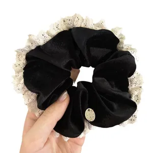 Retro velvet scrunchie with white lace trim and metal tag for elegant hairstyles
