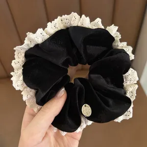 Vintage black velvet scrunchie with cream lace trim and gold metallic oval charm