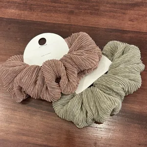 Elegant metallic silk scrunchies in rose gold and champagne gold with pleated texture