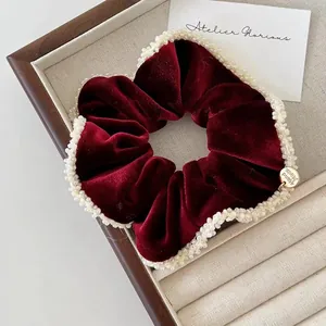 Elegant wine red velvet scrunchie with white pearl trim and a gold handmade charm