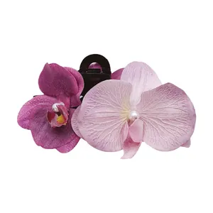 Elegant purple butterfly orchid hair claw clip with faux pearls on black base