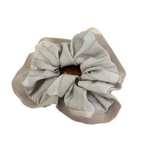 Minimalist oversized scrunchie featuring blue and beige mesh texture on a white background